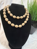 Tan plastic beaded necklace, $7.00